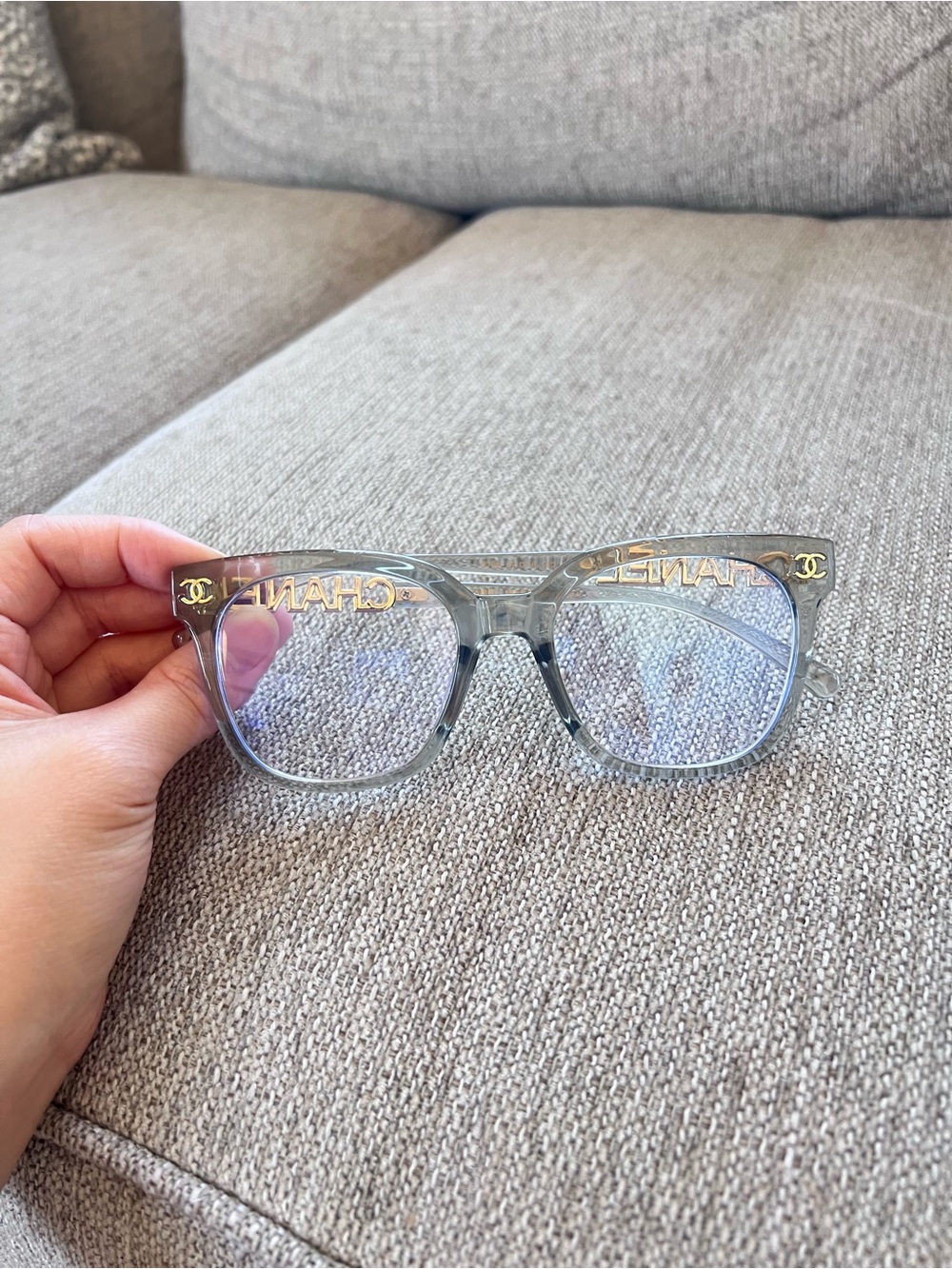 CHANEL Transparent Light Blue Frame Glasses with Gold Logos